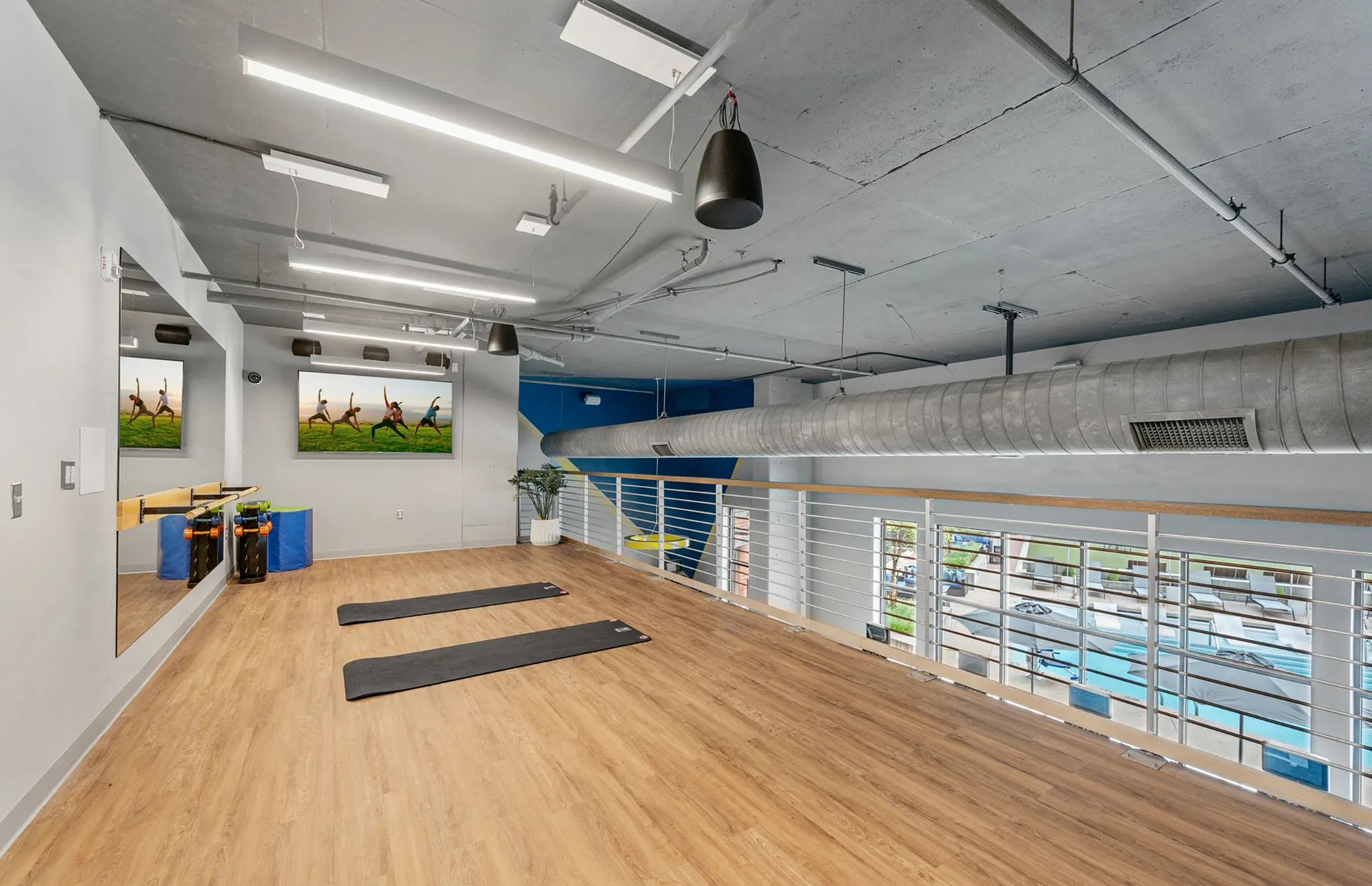 Bright, spacious fitness studio with mats