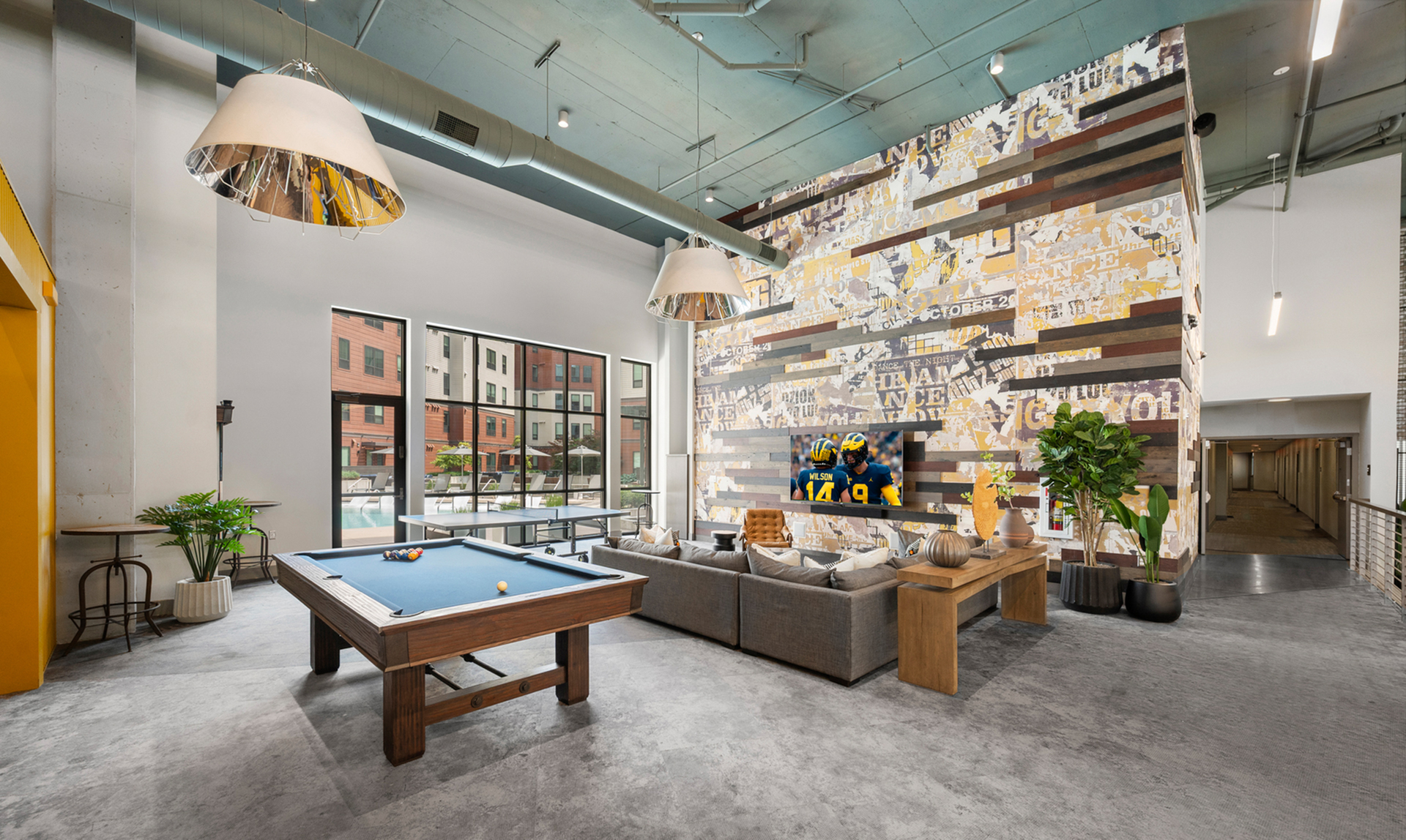 Artistic common space with a pool table and couches