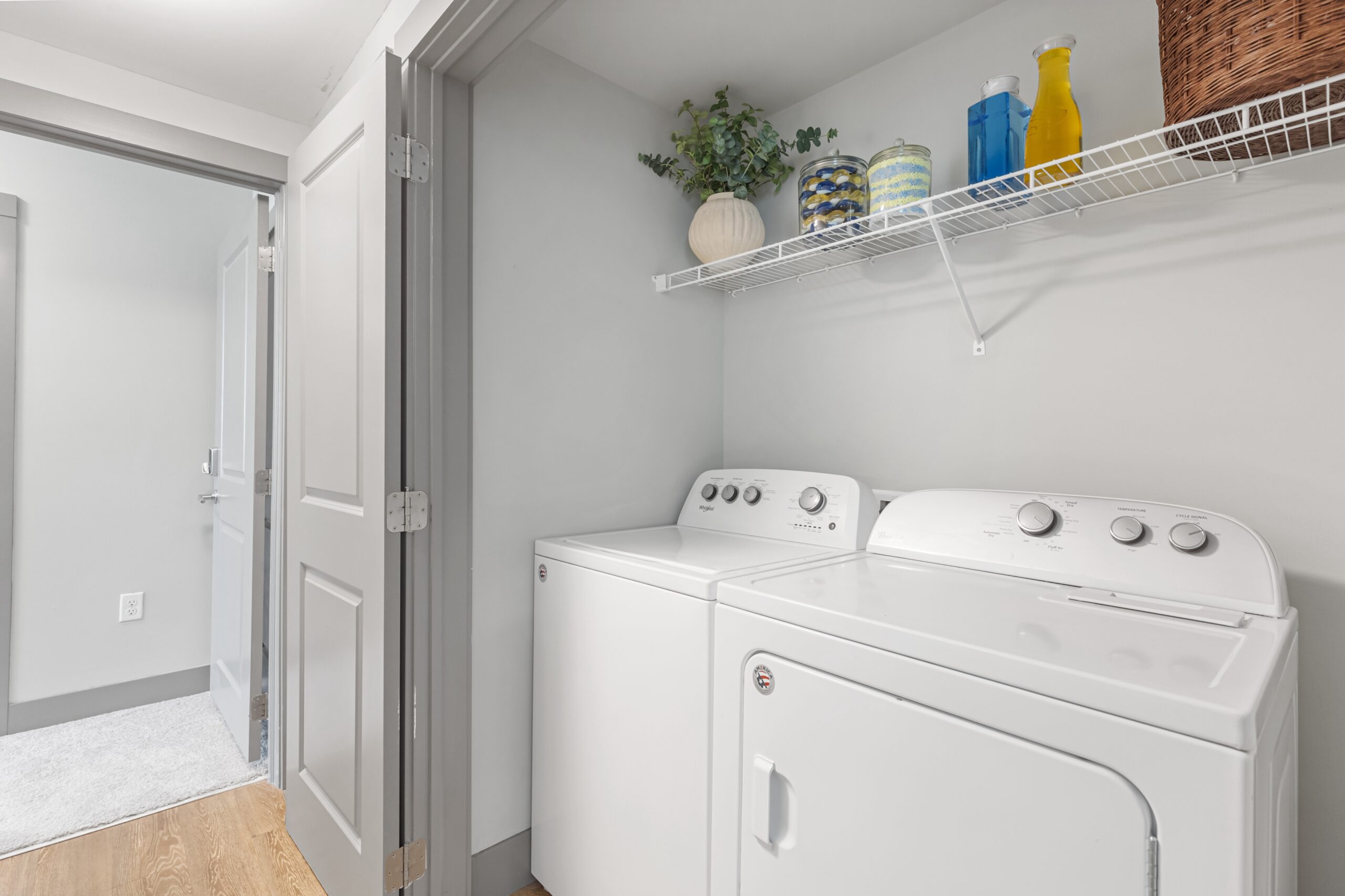 Bright and clean laundry room with white appliances