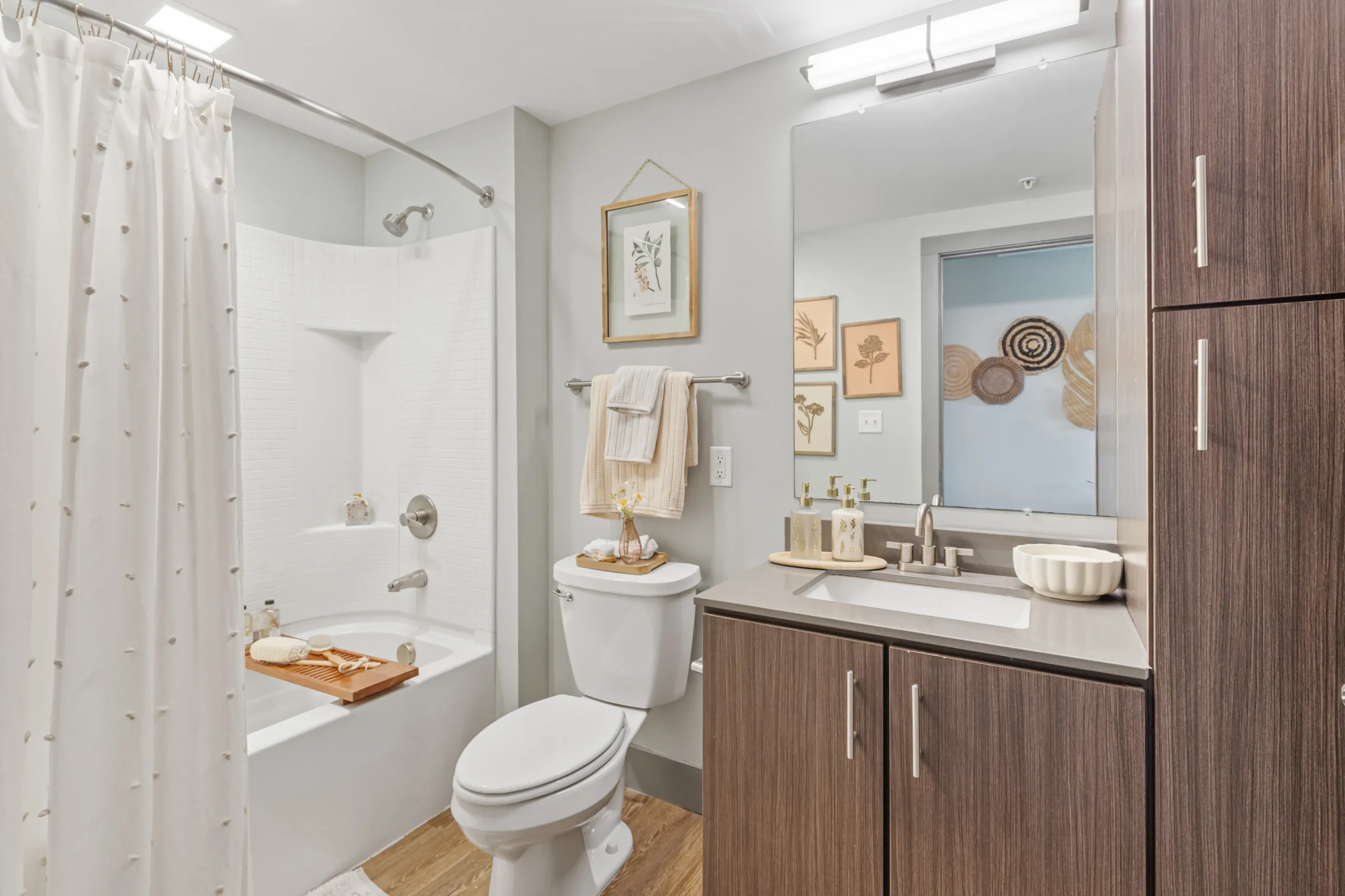 Modern and bright bathroom with mid brown cabinets
