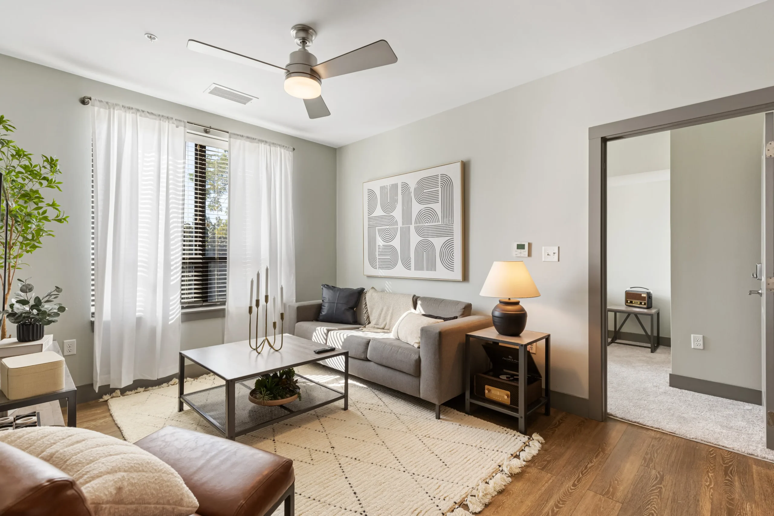 Updated and bright living room with leather and dark metal furnishings