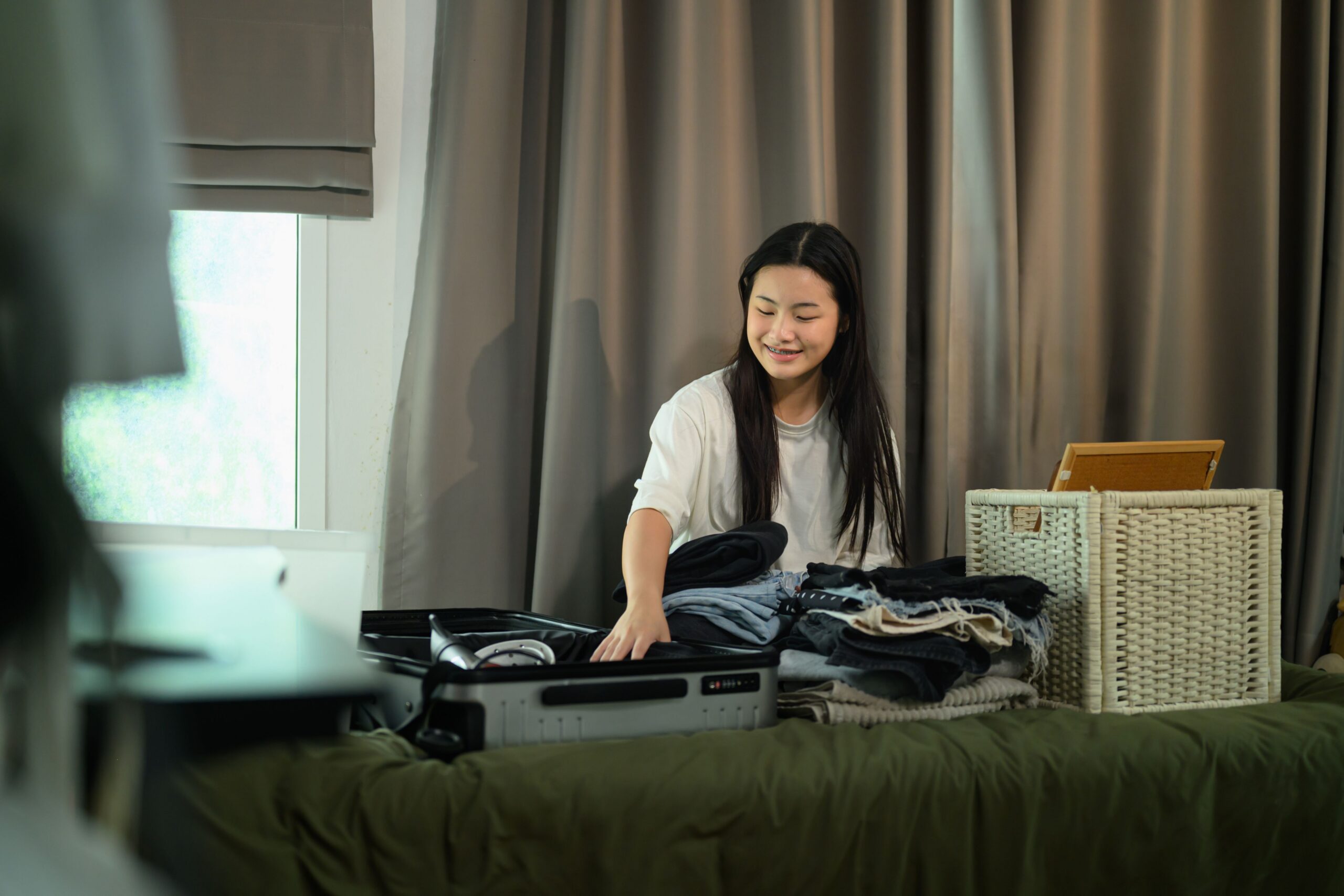 woman packing clothes into suitcase scaled